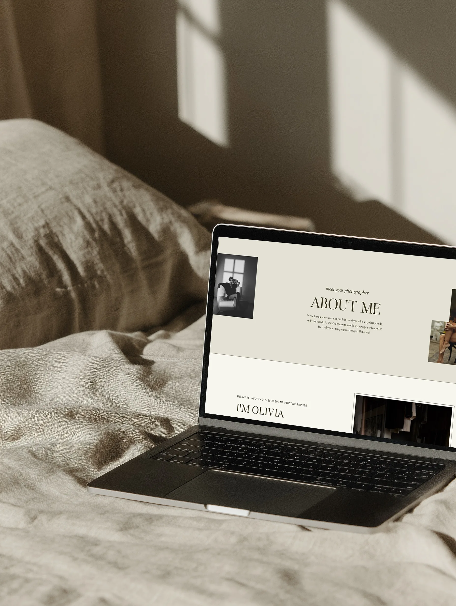 Laptop on a bed showing an About Me website page in soft natural light.