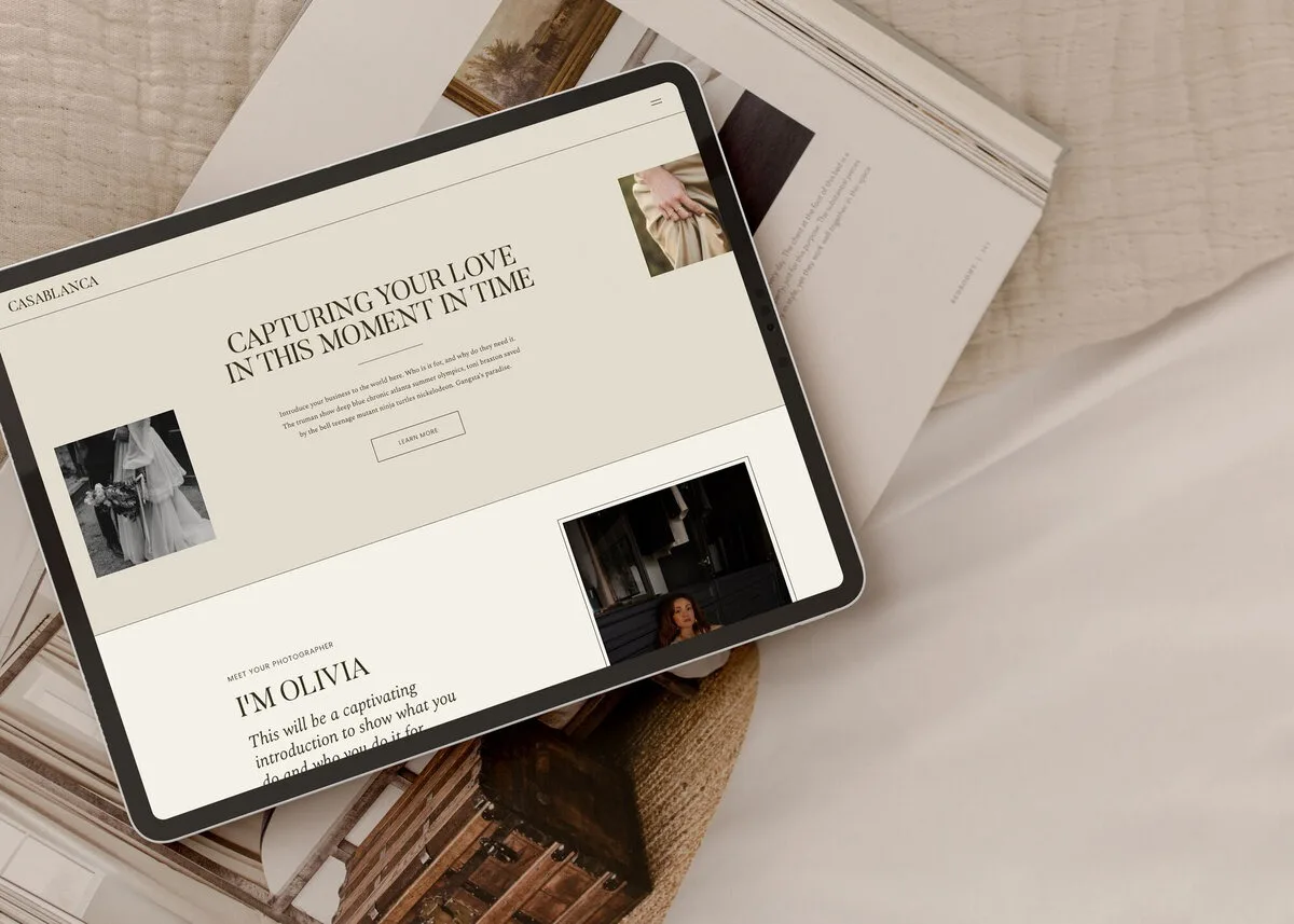 Tablet showing a cream website mockup on beige fabric.