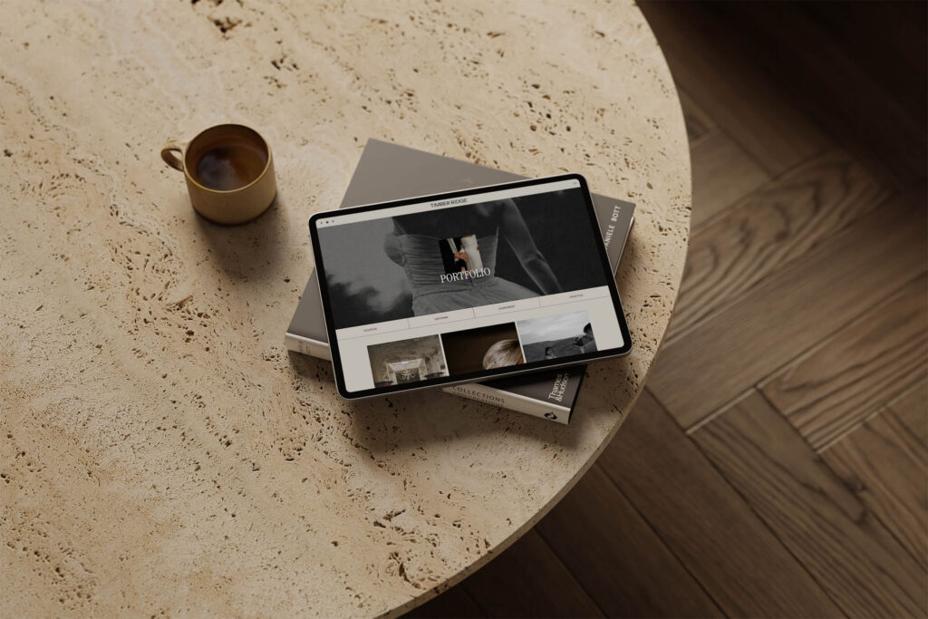 Showit website template for photographers displayed on tablet in styled neutral workspace mockup