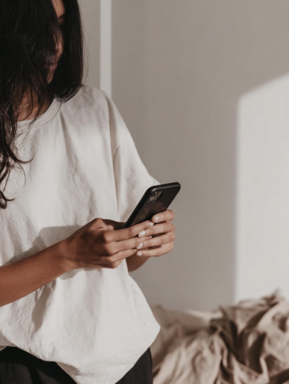 woman holding iPhone scrolling social media